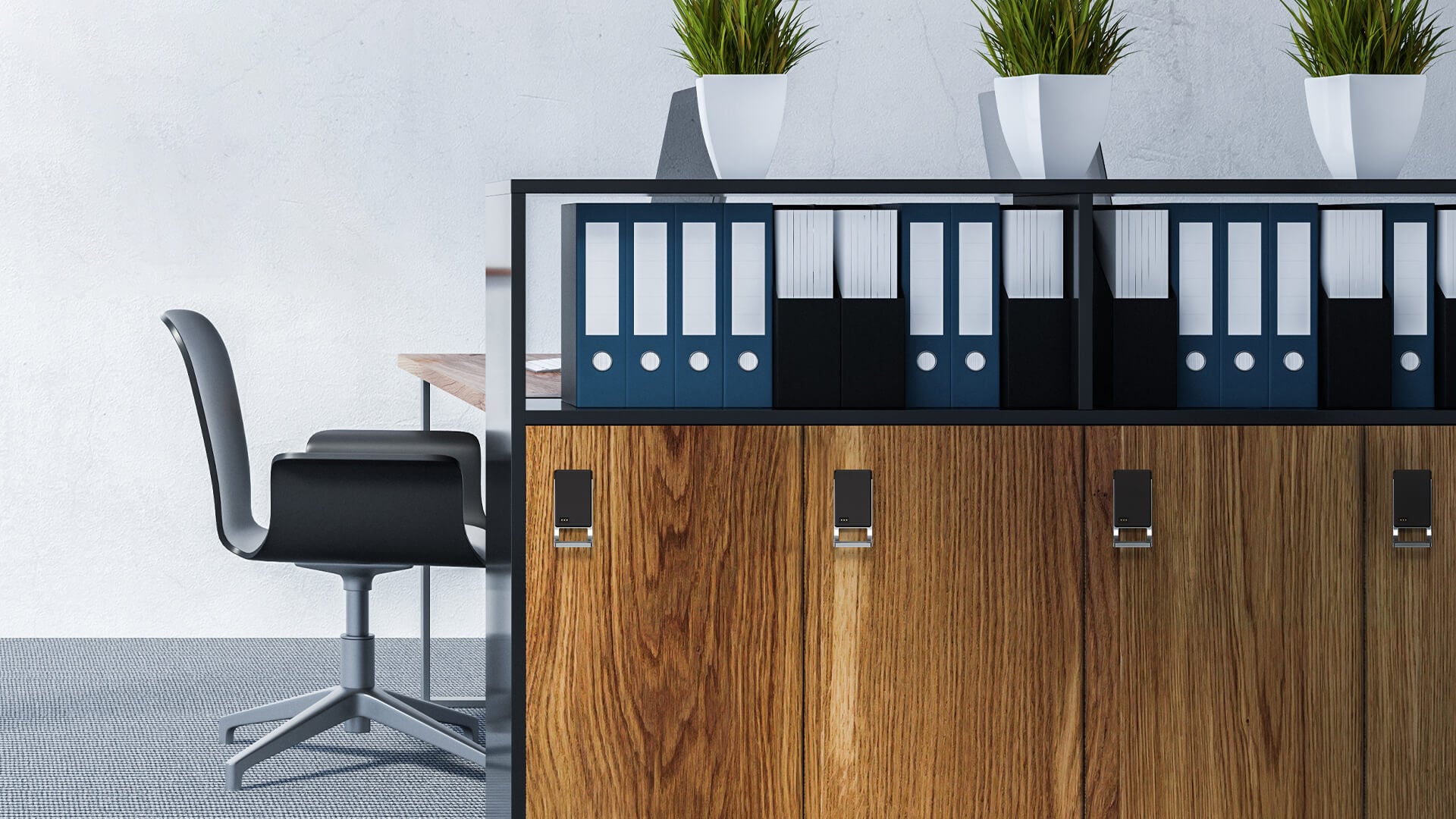 Modern office storage cabinet with wood-grain doors, colorful binders, and potted plants, beside a black desk chair; tidy, calm workspace.
